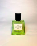 Green perfume bottle with black cap on a gradient background . cadeline_lunhaw_green_woody_visayan_perfume_1